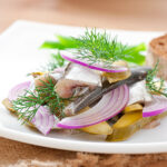herring salad with pickled cucumbers and onions